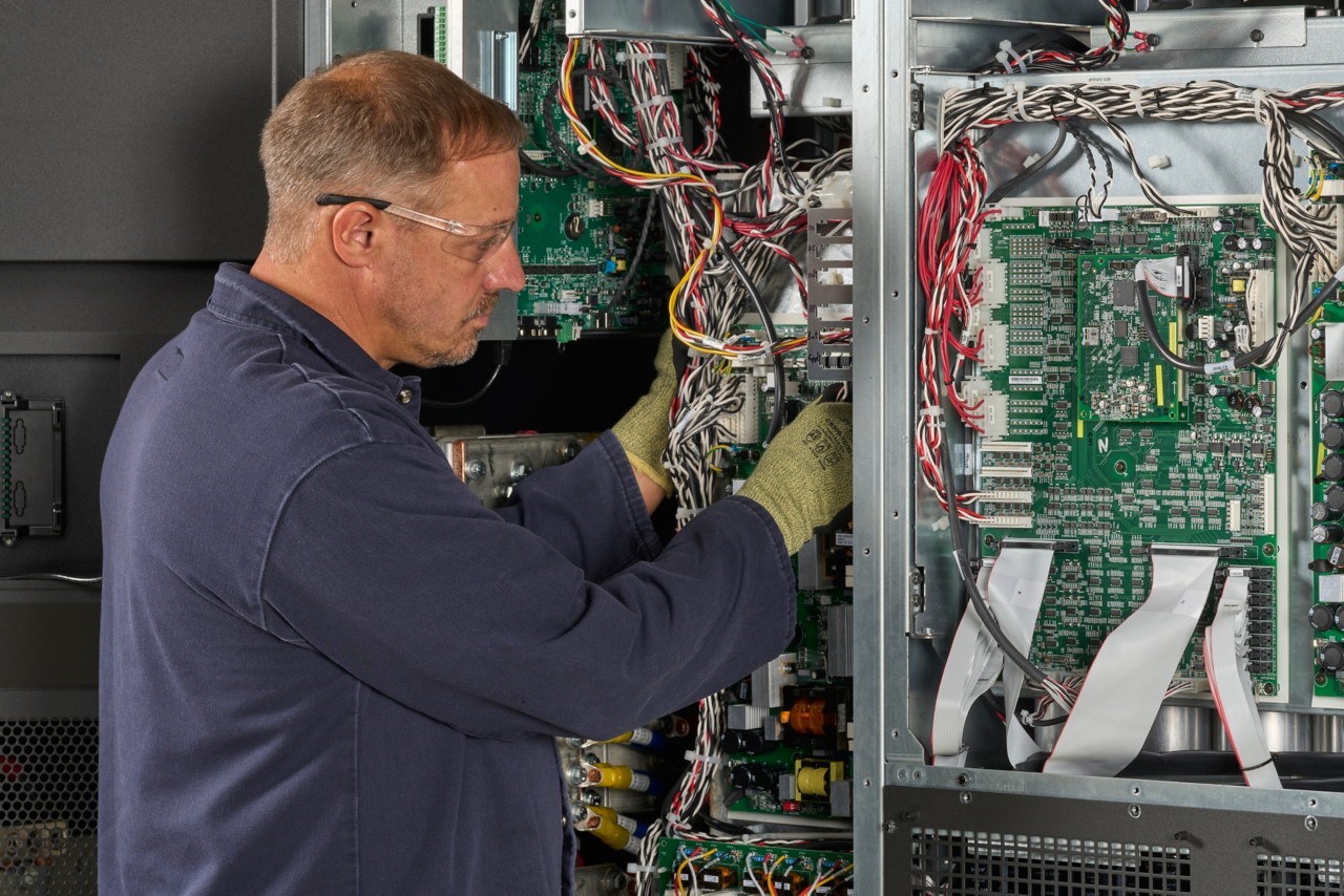 Man performs service on 9395XC inspecting CU