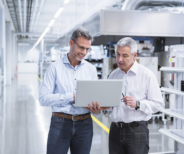 businessmen-production-floor-with-laptop-getty-717170327